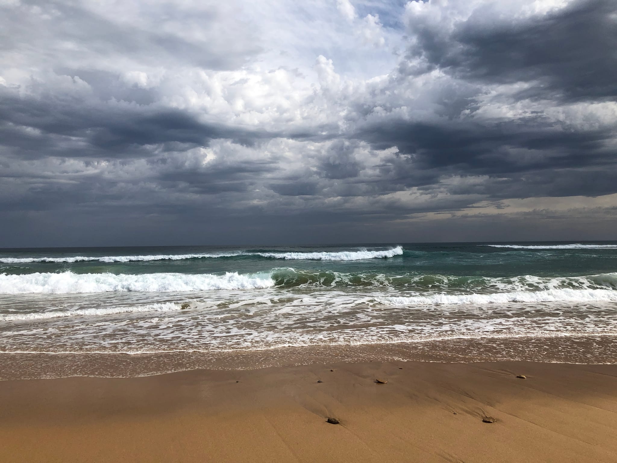 Breaking surf under a dramatic sky at Gunnamatta ocean beach on the Mornington Peninsula