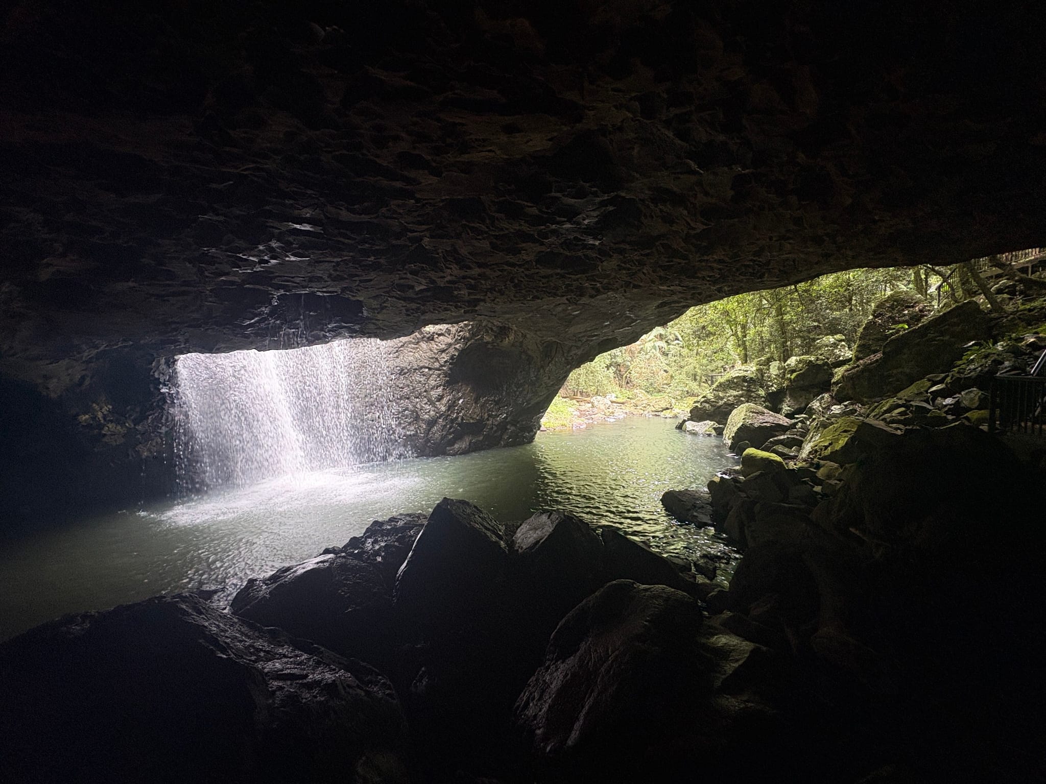 A waterfall pouring through the roof of the cave at Natural Bridge in Springbrook National Park