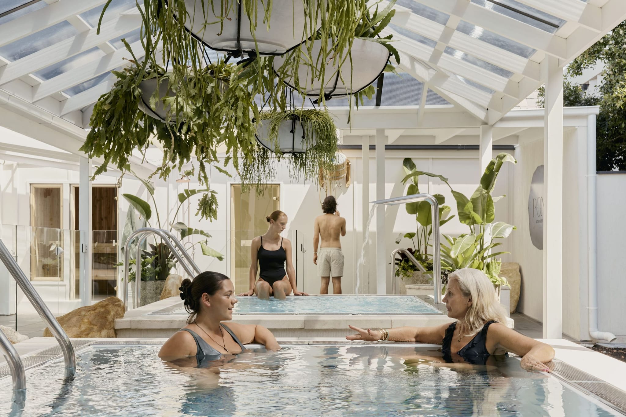 Magnesium mineral pool under a glass roof at POND Bathhouse in Mornington, with hanging plants