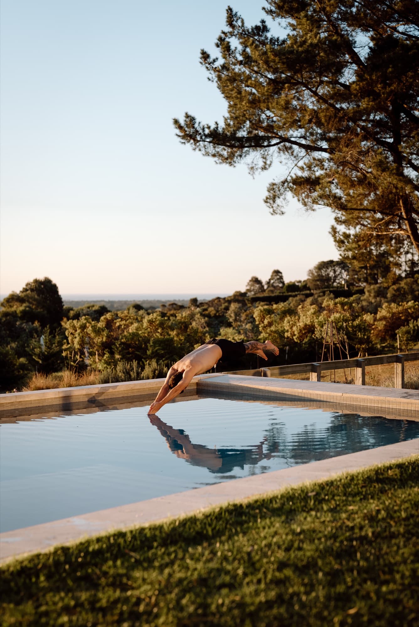A guest diving into the pool at Villa Floretti, Boneo