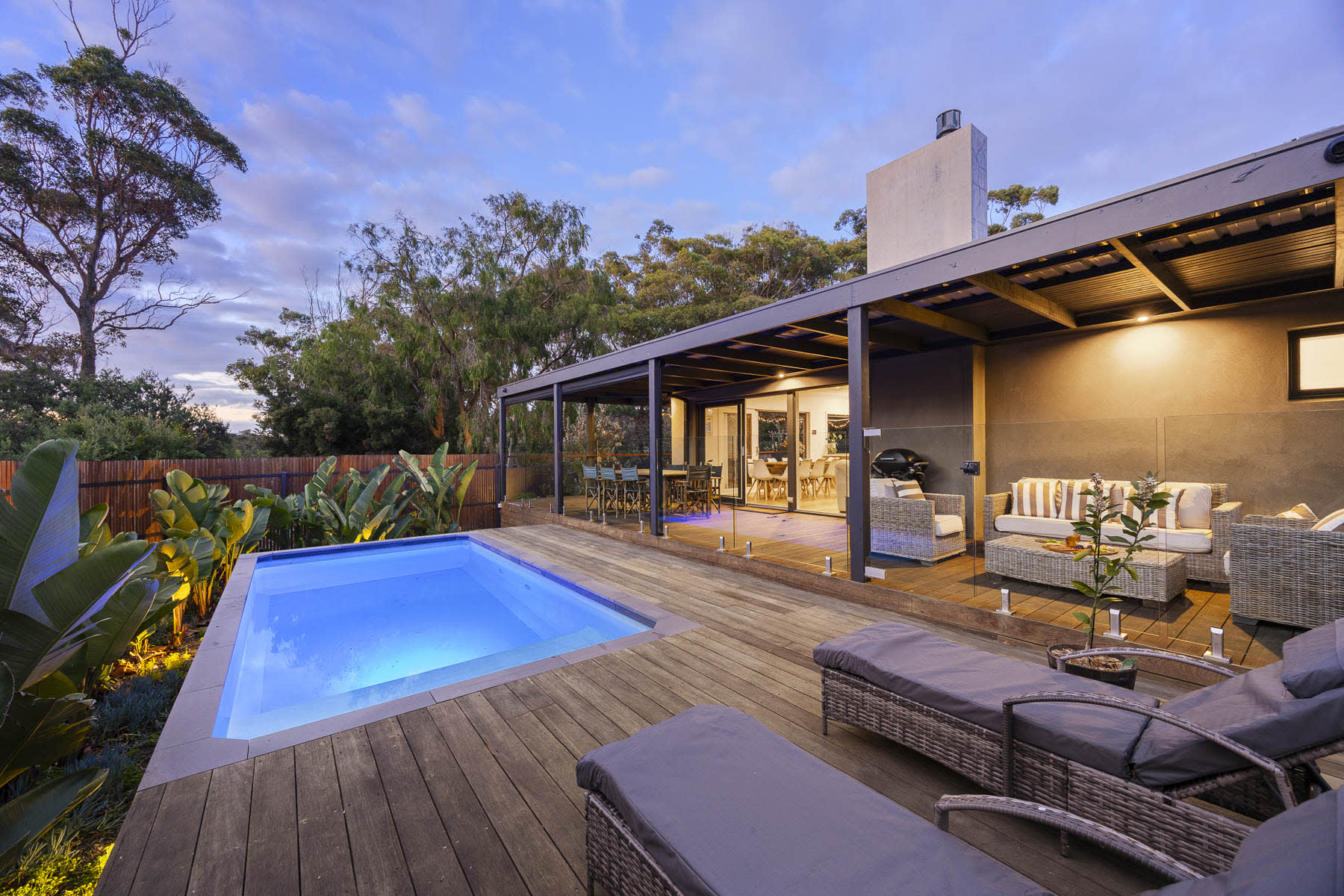Pool and covered deck at Galene, Mount Martha, glowing at dusk