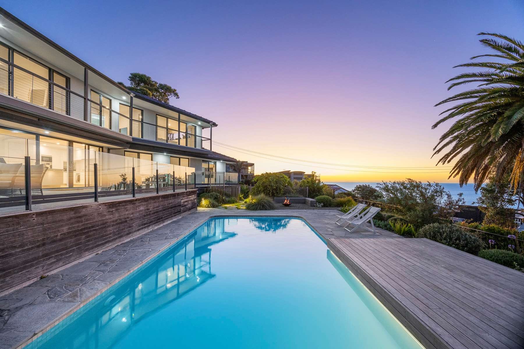 Pool at Villa Luminosa at dusk with the bay on the horizon