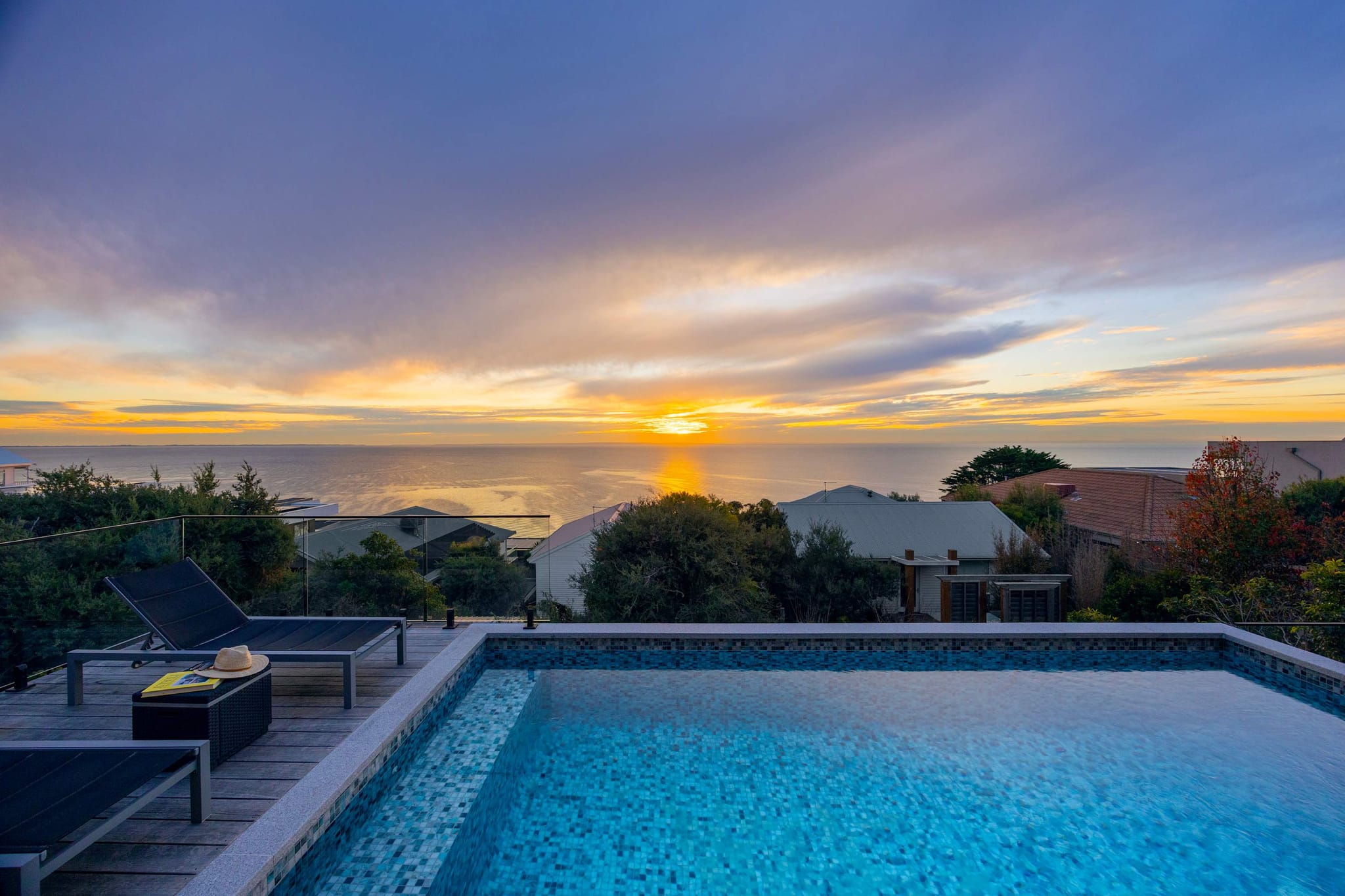 Sunset over the bay from the pool deck at Azure Horizon