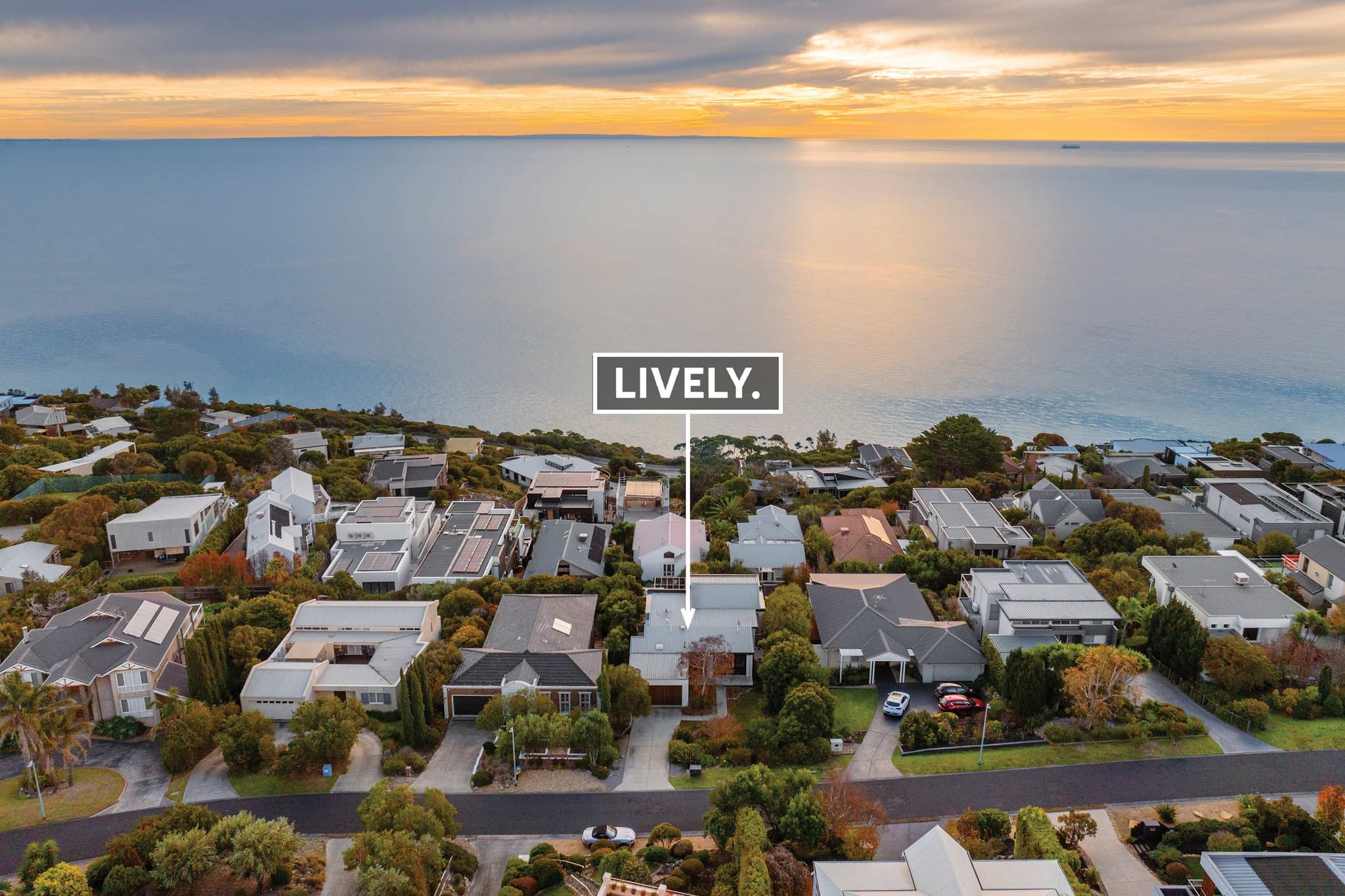Aerial view at sunset of Azure Horizon among the Mount Martha streets above the bay
