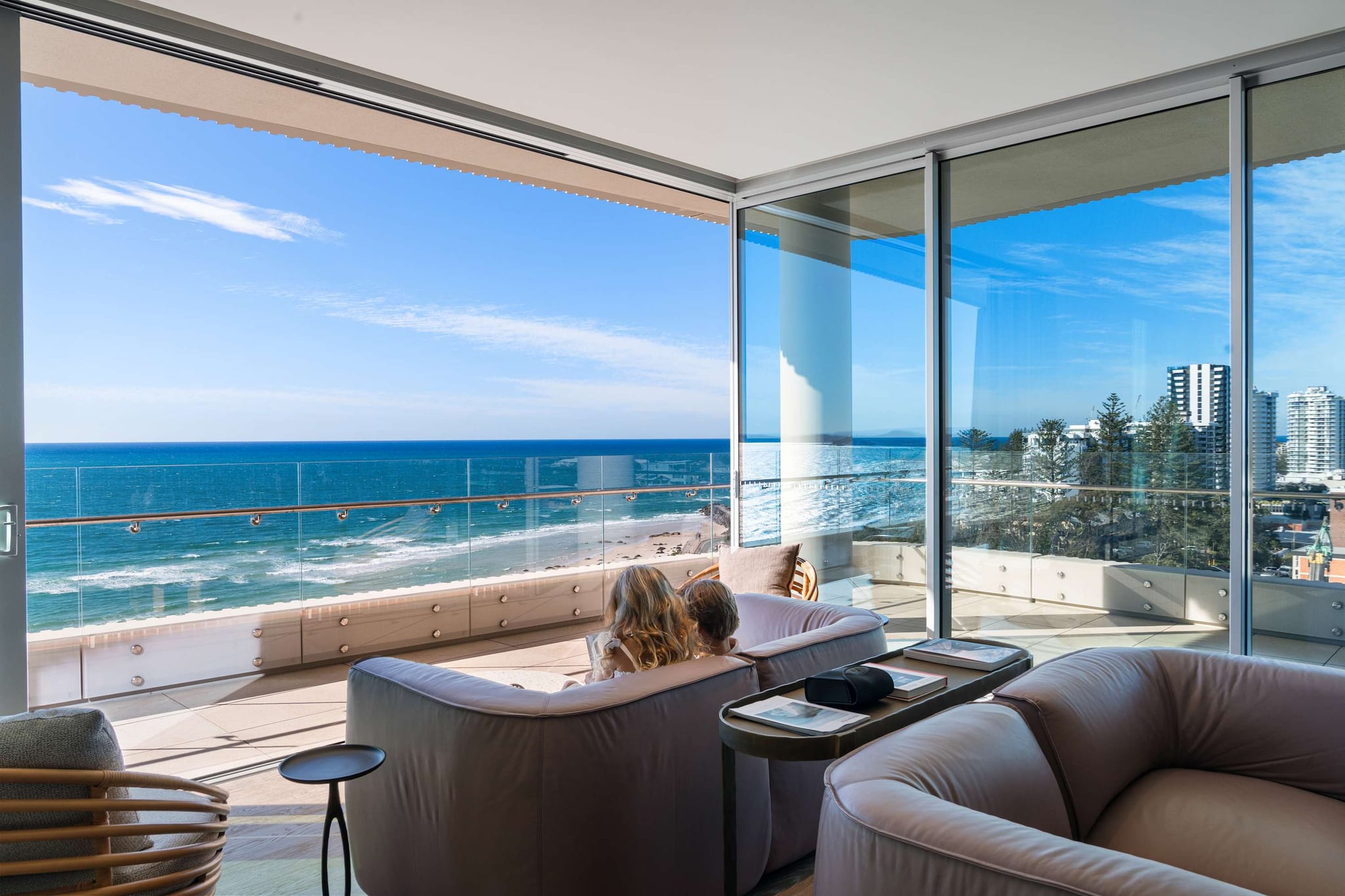 The living room at RISE, with floor-to-ceiling glass looking over Kirra Beach