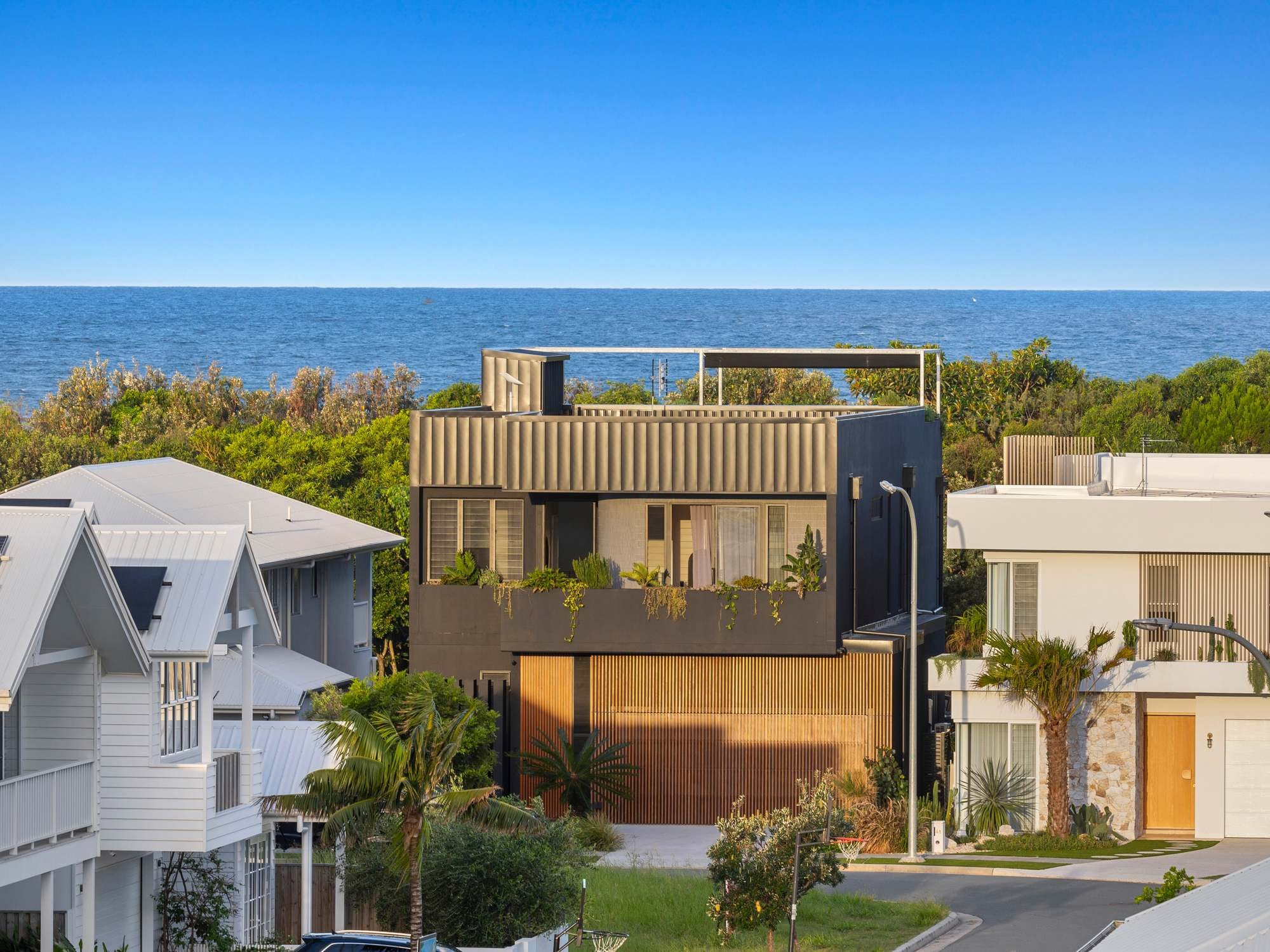 An aerial view of Black on Black Wattle with the ocean behind it