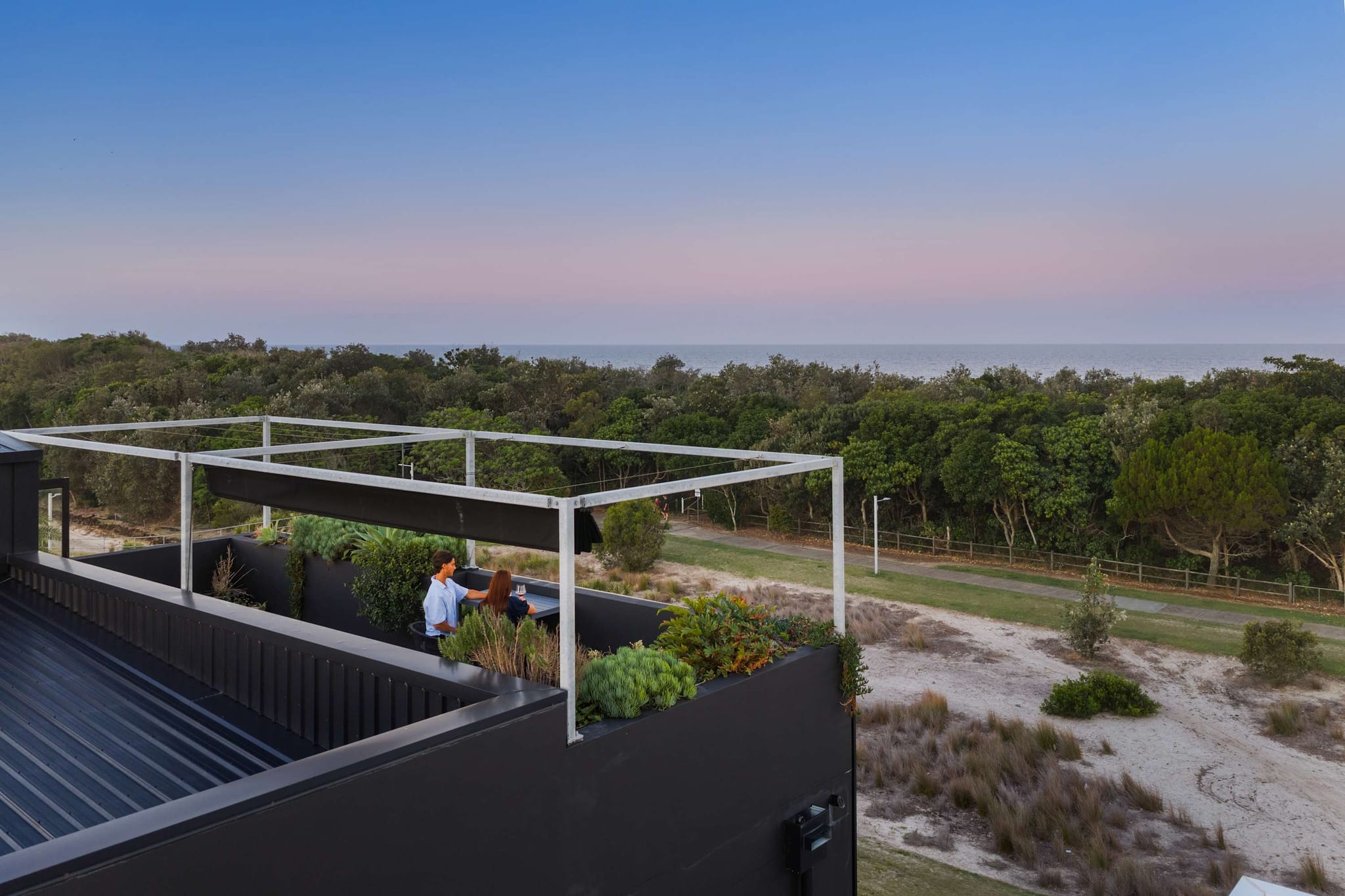 The rooftop terrace at Black on Black Wattle, with the dunes and the ocean behind