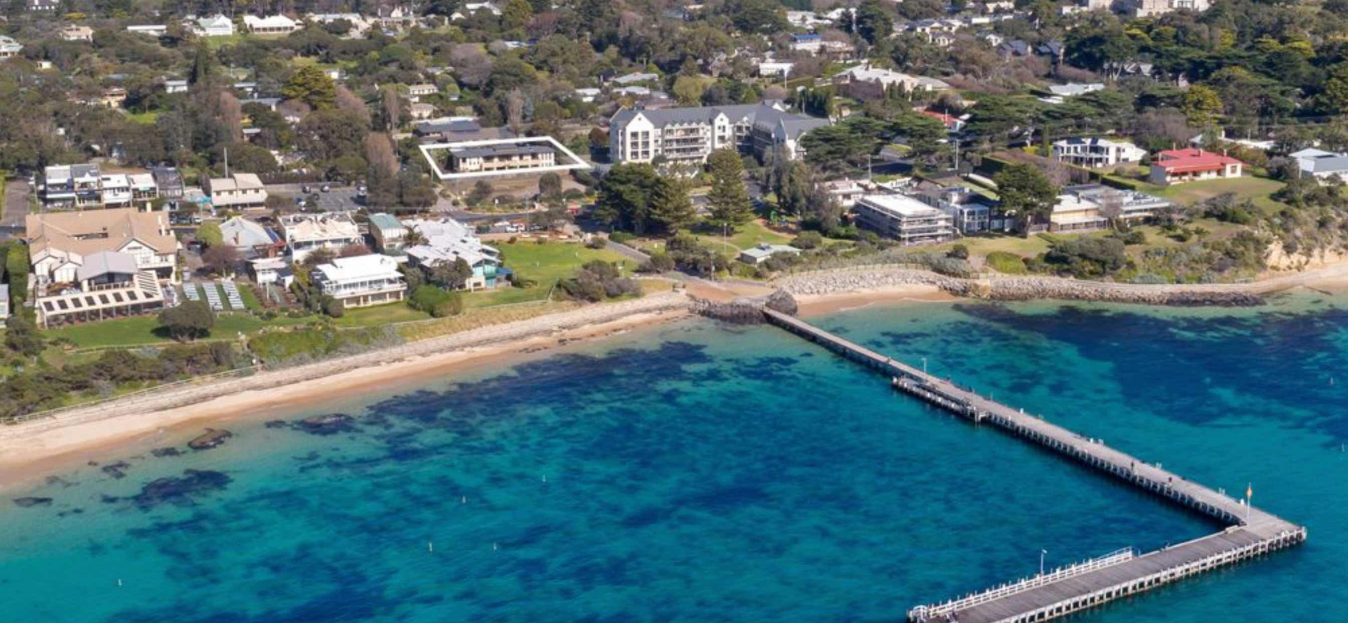 Aerial view of Portsea Pier and the clear water of the bay, with Nepean House marked