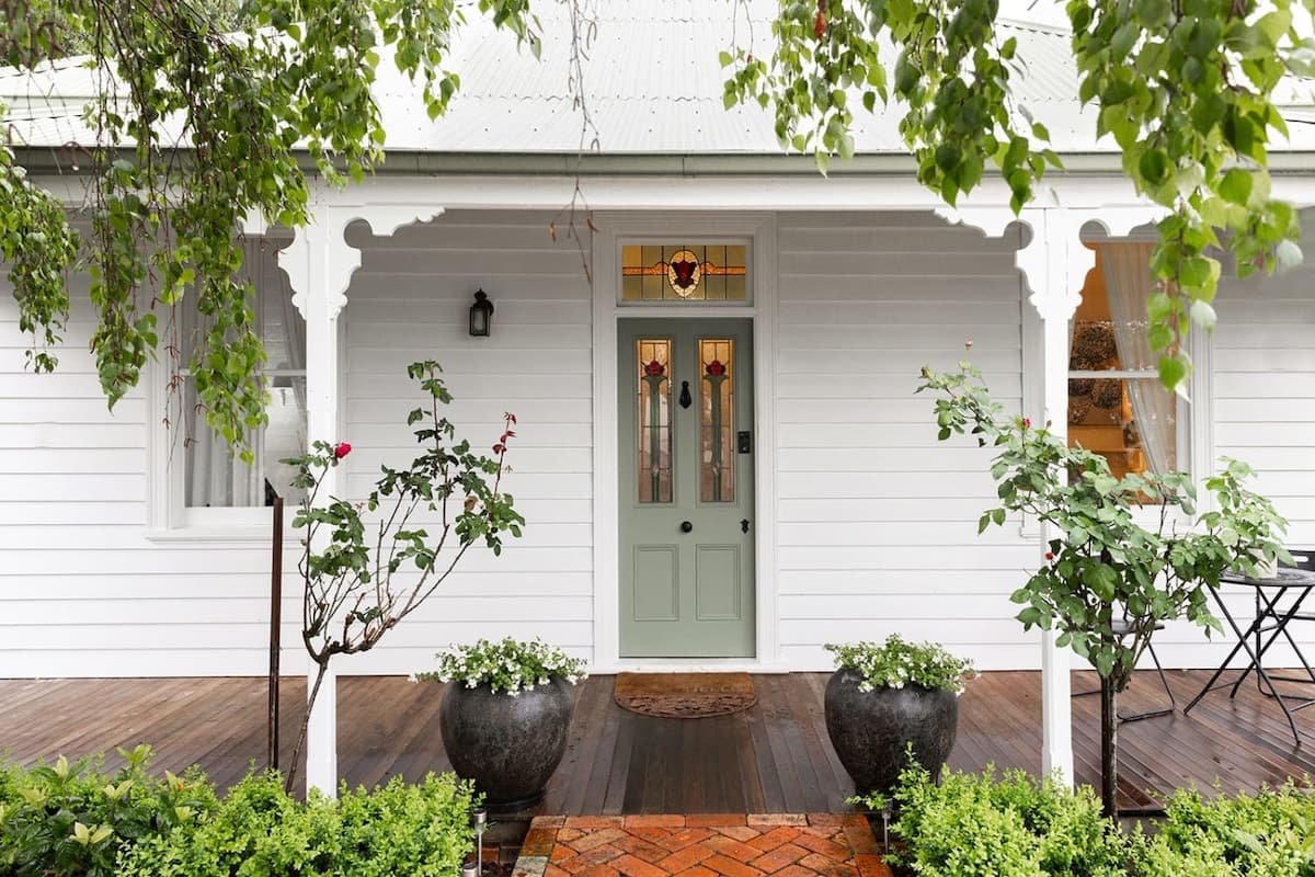 The sage green front door and deep porch at Oliver's Cottage