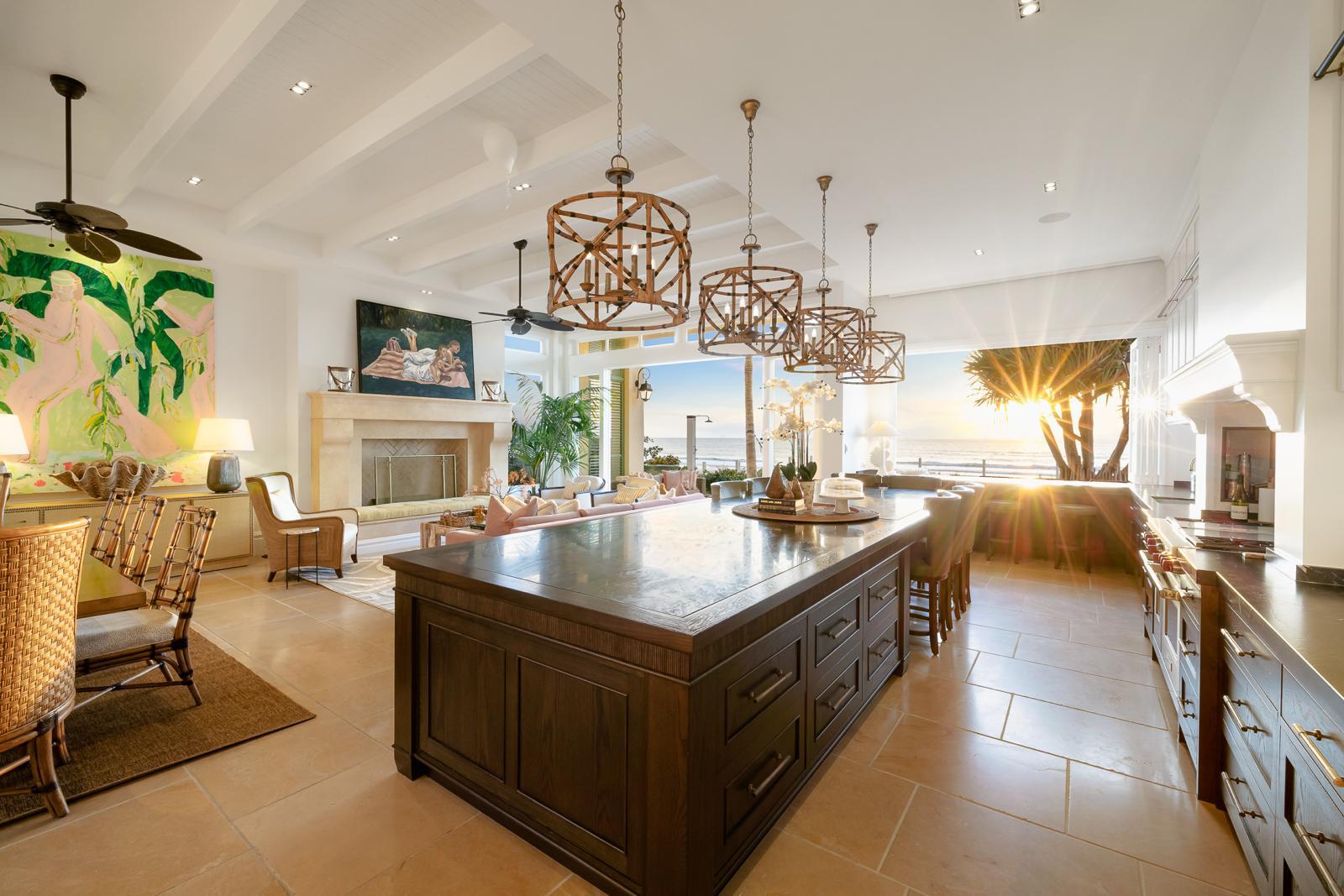 Kitchen with its quartzite island, dining and living beyond