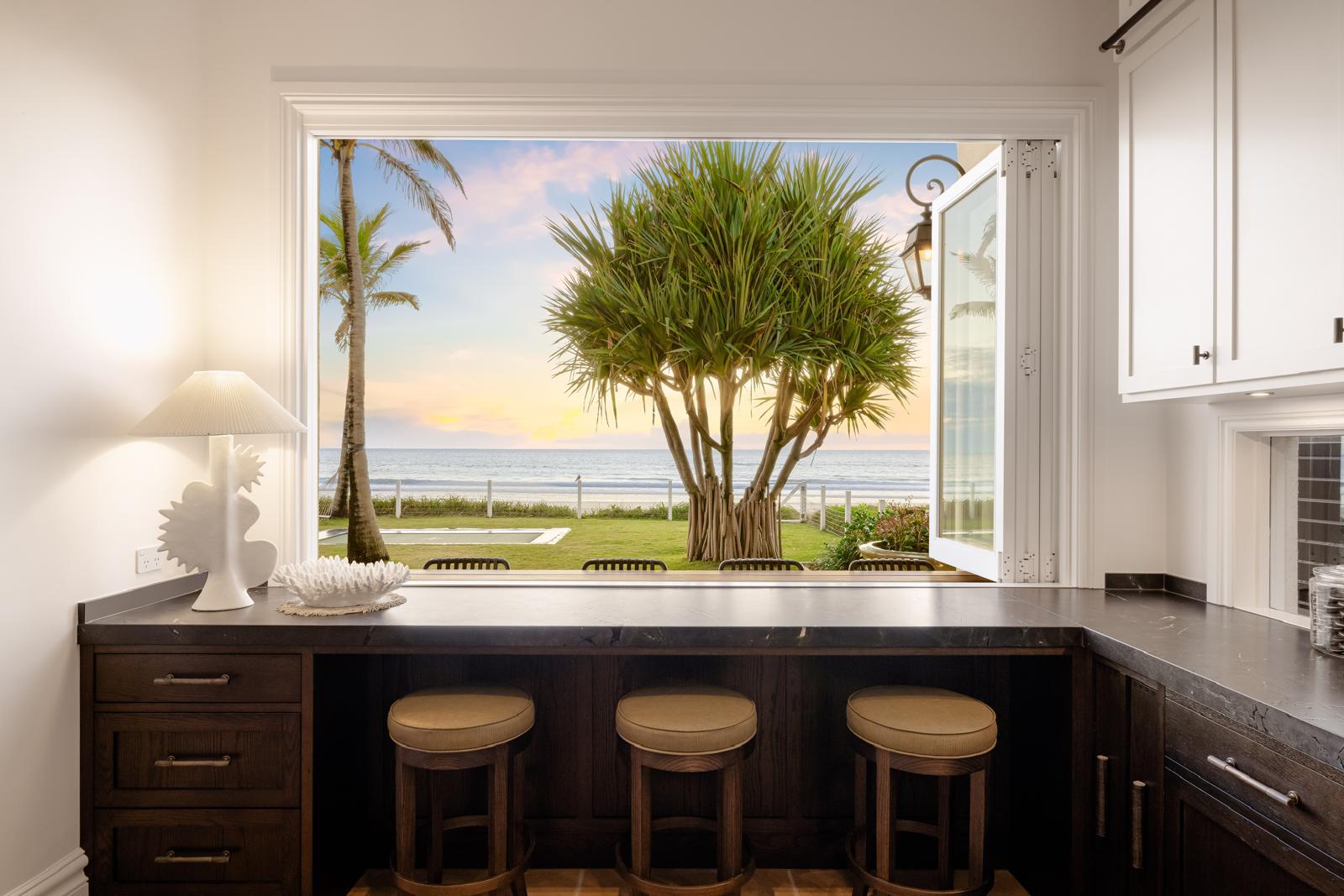 Servery window with bar seating looking out to the ocean