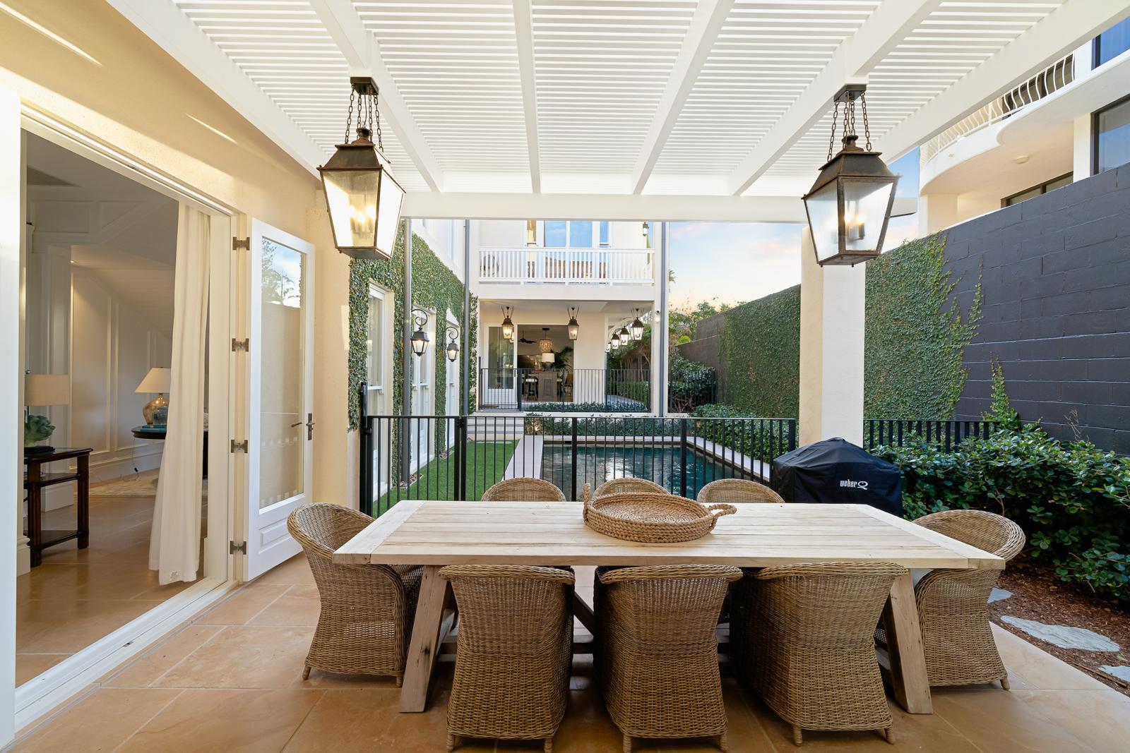Covered outdoor dining beside the pool